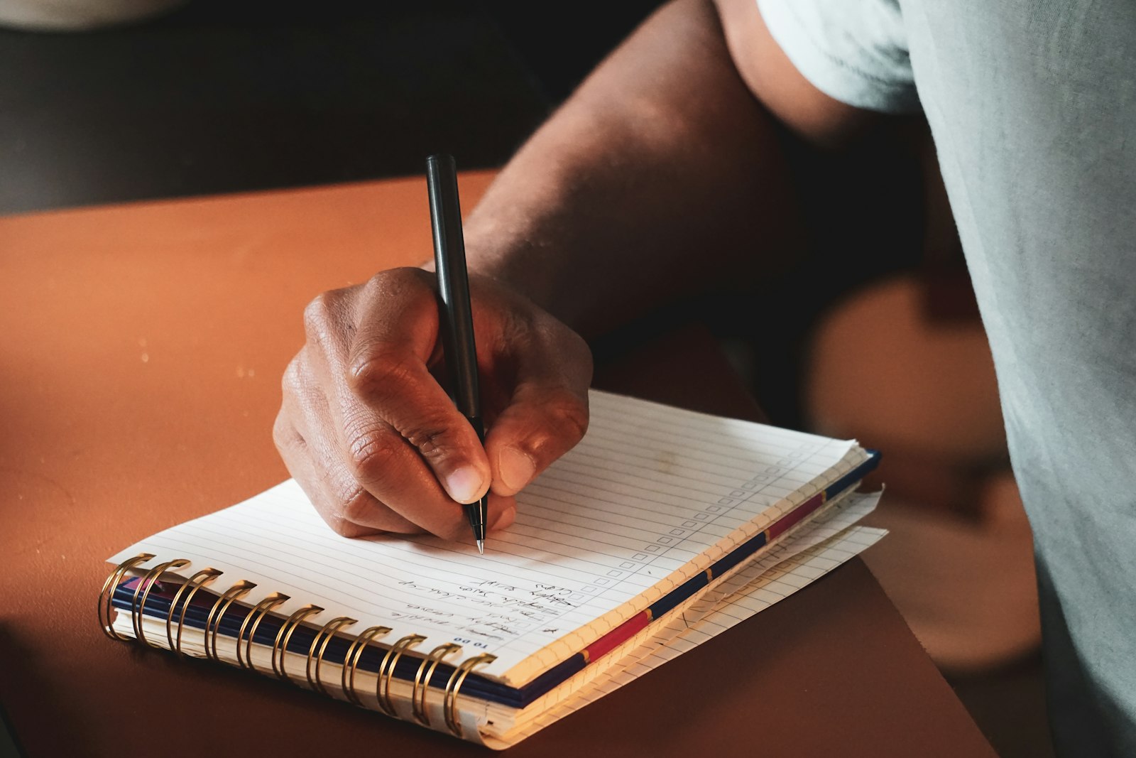 A hand marking up a manuscript page with a red pen during revision