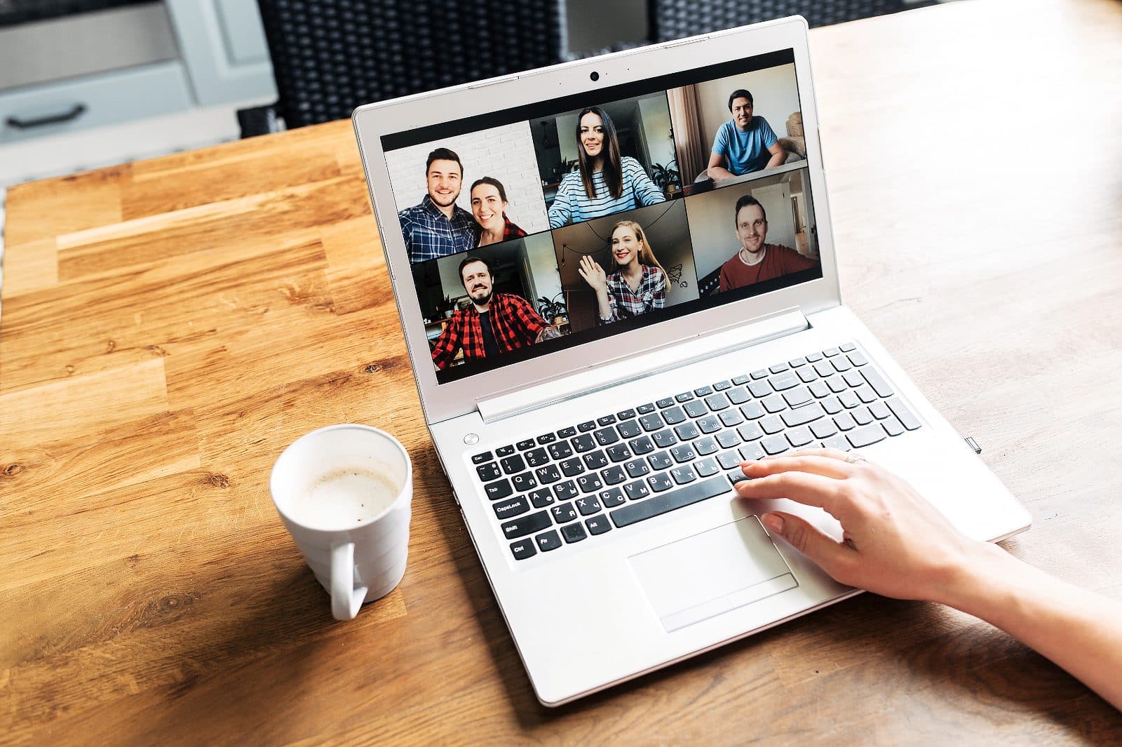 A writer on a laptop in a video call with other First Draft members